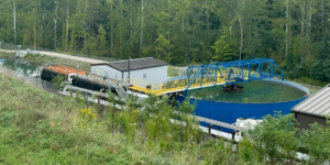 Mine Pool pump and treat system. Photo showing three-stage reaction tank consisting of hydrogen peroxide reactor, Enhanced Flocculation reactor, and polymer flocculation tank followed by a 21-meter diameter shaft-driven conventional clarifier. three-stage-reaction-tank